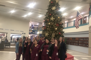 group at hospital in front of christmas tree