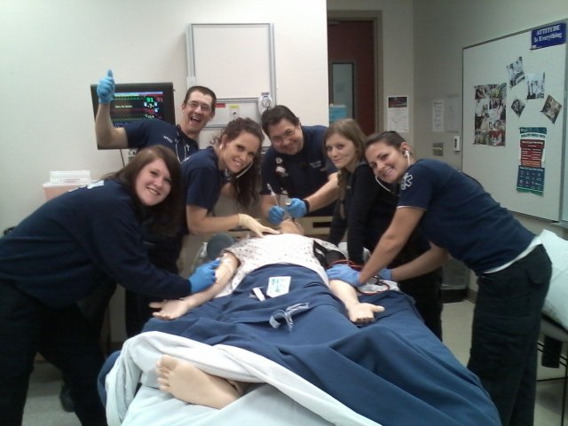 EMS Students posing with SIM man
