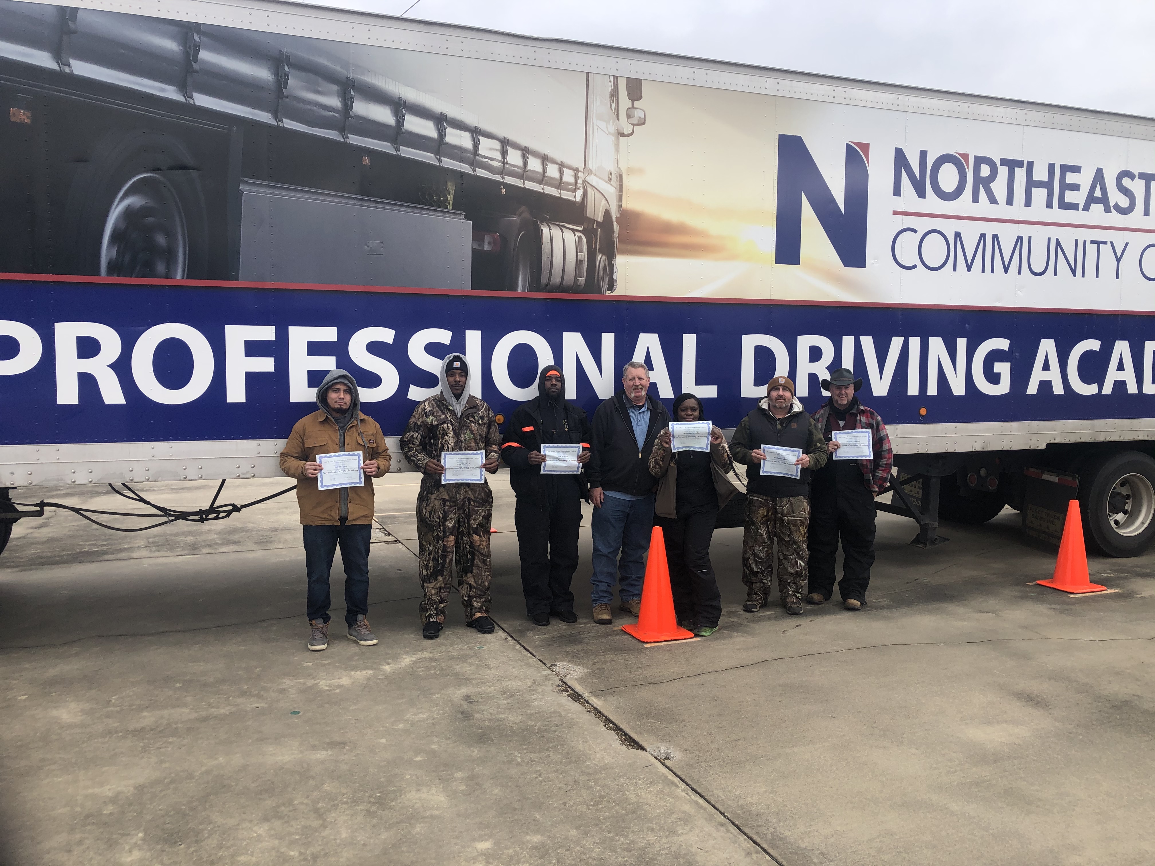 driver graduates in front of truck