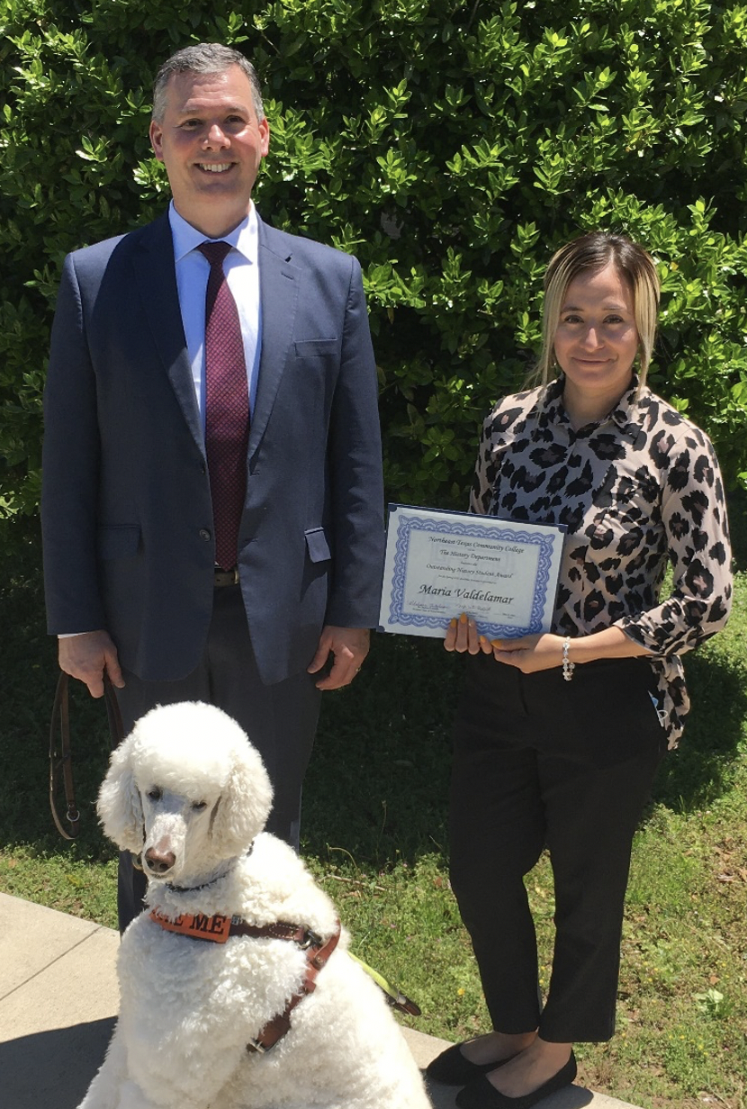 John Russo presents certificate to Maria Valdelamar