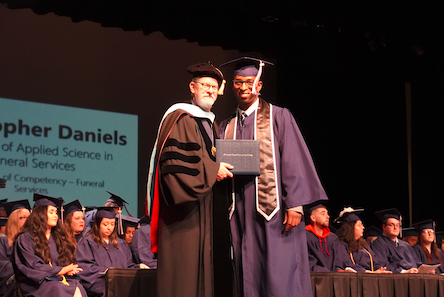 student receiving diploma