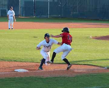 Caleb Reynolds making a tag for an out at third base.