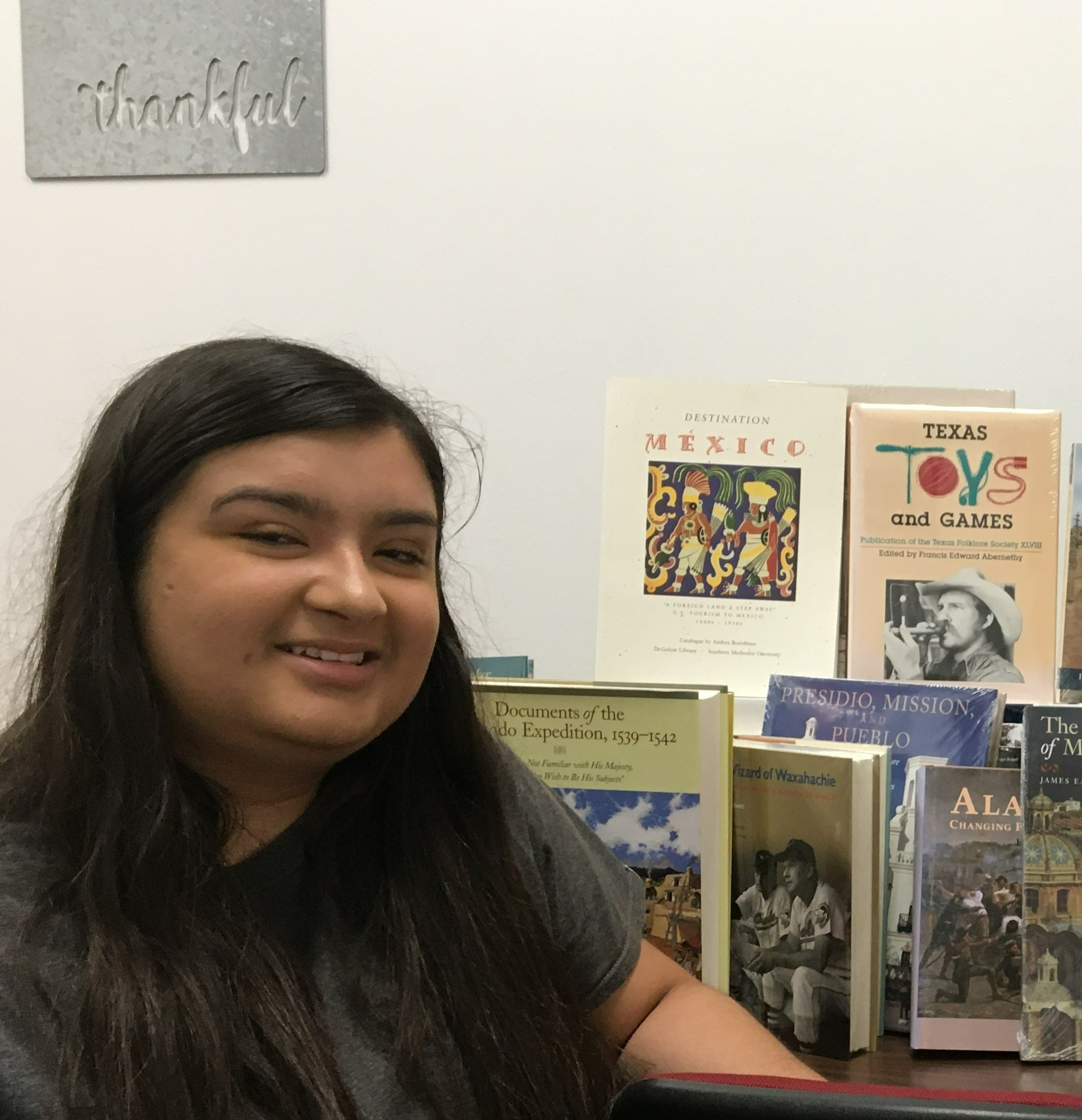 honors scholar with books that were donated