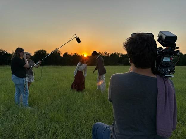 filming in field at sunrise