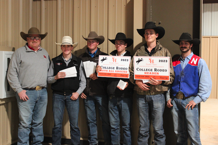 men's rodeo team with coach