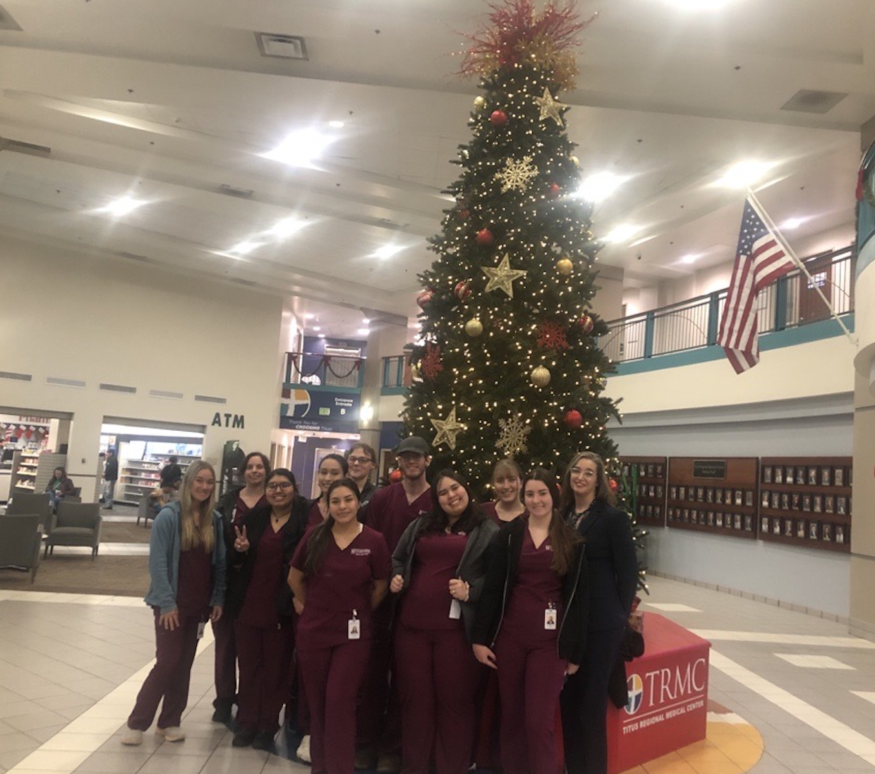 group at hospital in front of christmas tree