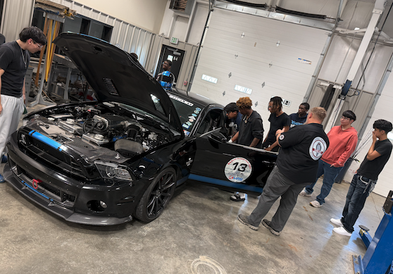 students looking at Shelby car