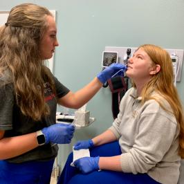 Medical Assistant student administering test on another student
