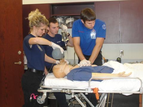 EMS Students administering CPR on SIM man