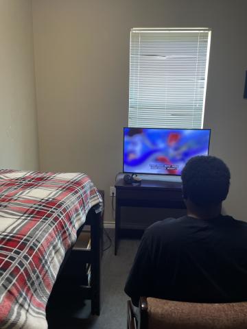 teenager plays video games in dorms