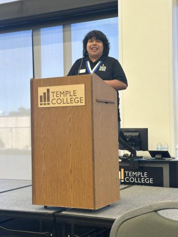 Jose Fuentes speaking at podium
