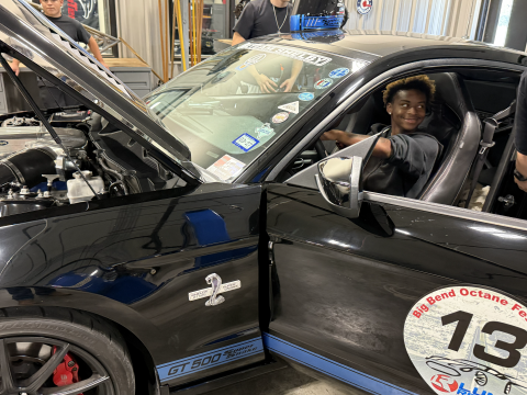student sitting in drivers seat