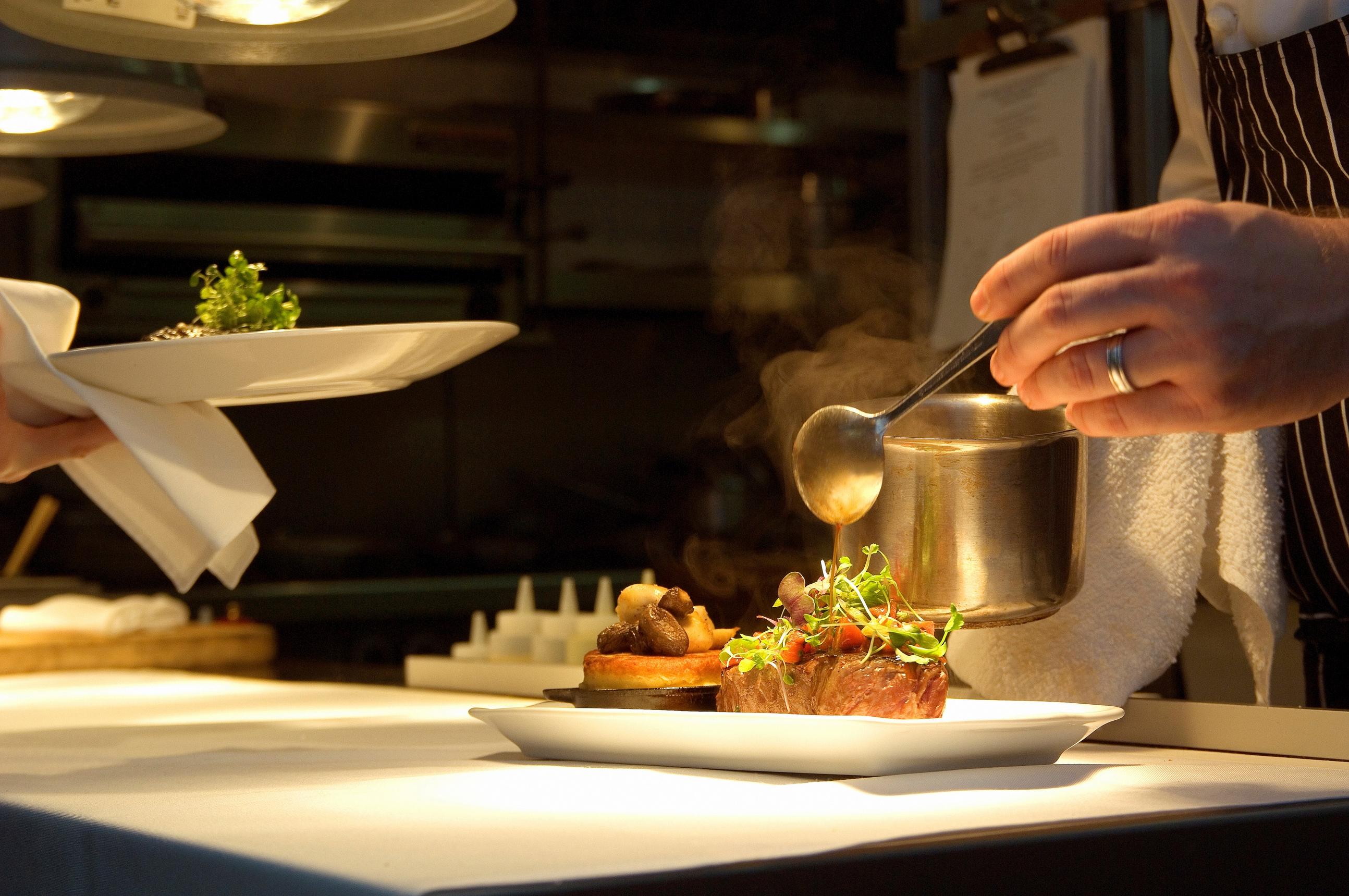 A chef plating food.