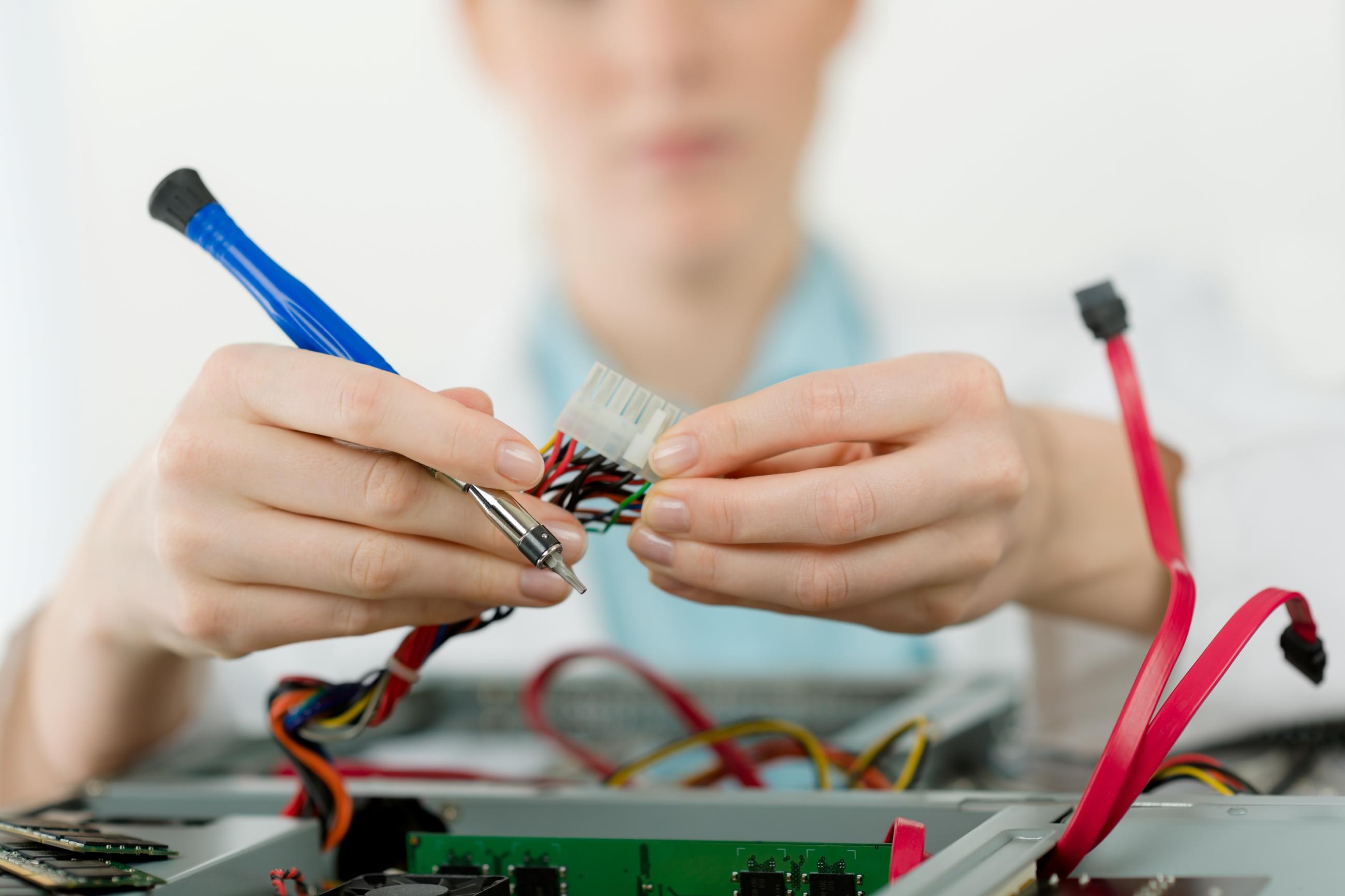 Computer repair tech working on computer