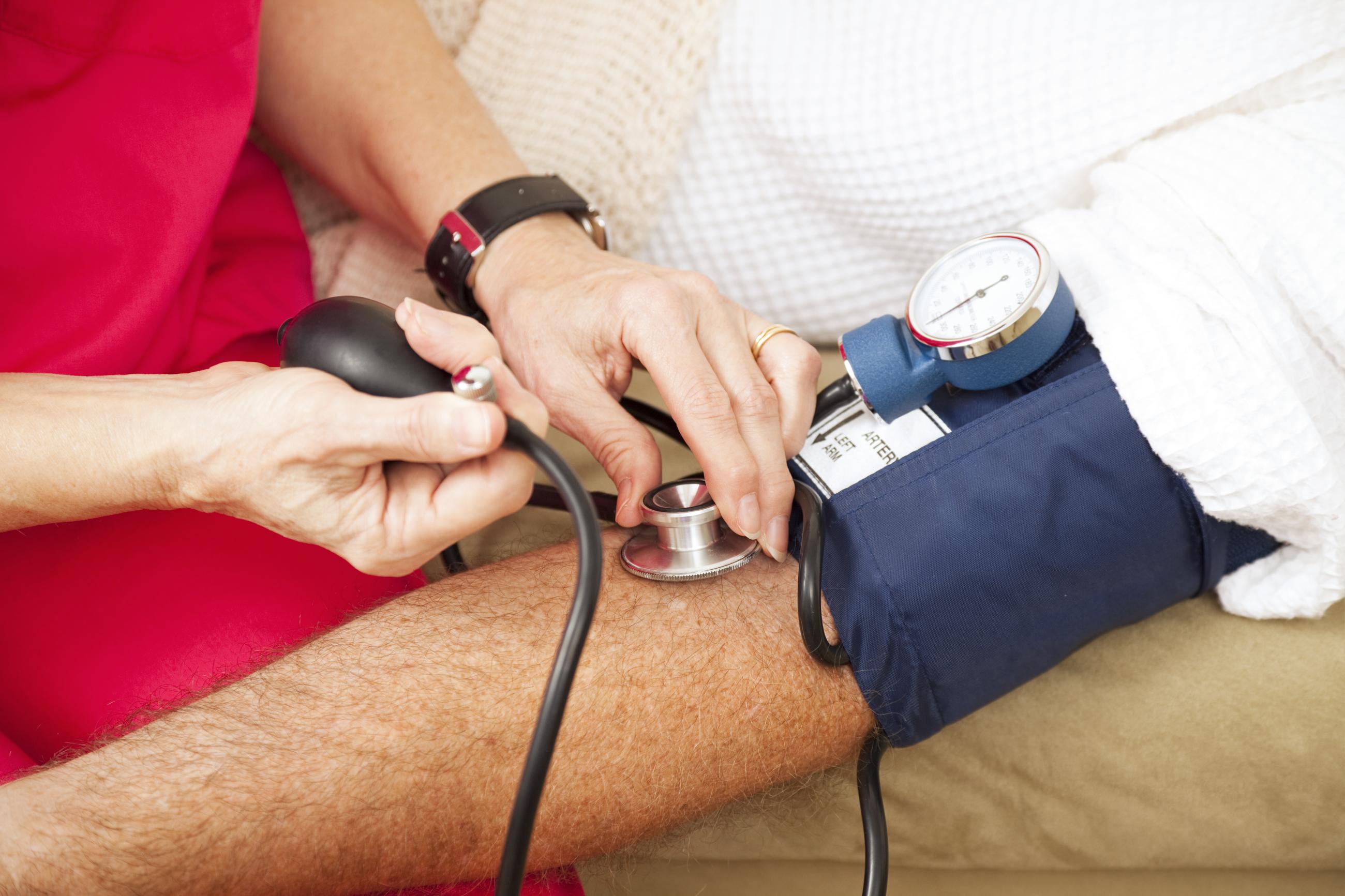 Checking patients blood pressure.