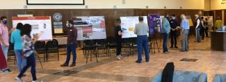 people gather in the whatley foyer for the poster contest.