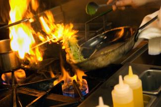 Culinary chef cooking with open flame
