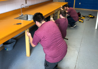 students working on sink