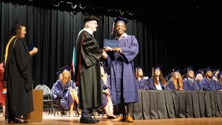 graduate getting diploma