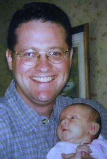 Patrick Barnes holding child.