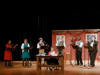 7 cast members on stage acting out scene