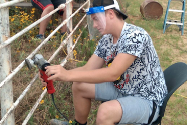 student working on fence
