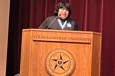 Fuentes speaking on stage