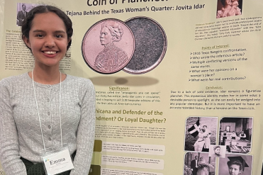 Mendoza in front of research poster