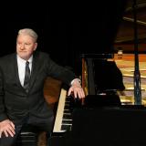 Clinton sitting at piano