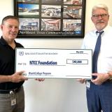 NTCC administrators accepting check