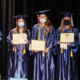 students on stage with their certificates
