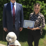 John Russo presents certificate to Maria Valdelamar