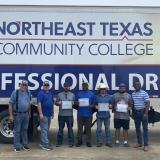truck driving graduates in front of truck