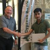 cypress bank president presents laptop to Make Estrada.