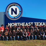 rodeo team group photo in front of NTCC sign.