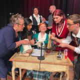 cast of play in costume.