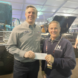 Aaron shelby presents check to Jon McCullough