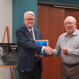 Frankie King receiving plaque from Dr. Clinton