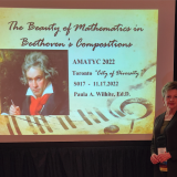 Wilhite in front of screen at conference