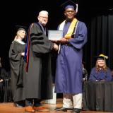 graduate receiving diploma