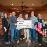 pure hope group presents big check