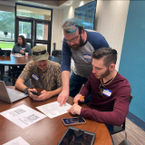 Dr. Drew Murphy assists students with judging. 