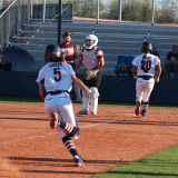 Pictured: Haley McAlexander (5) scoring one of her five runs on the day.