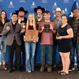 students posing with awards