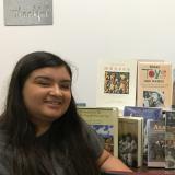 honors scholar with books that were donated