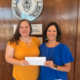 Denney presenting check to Nita May