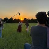 filming in field at sunrise