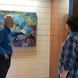 Herbert shows painting to student
