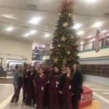 group at hospital in front of christmas tree