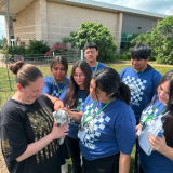 students with baby goat